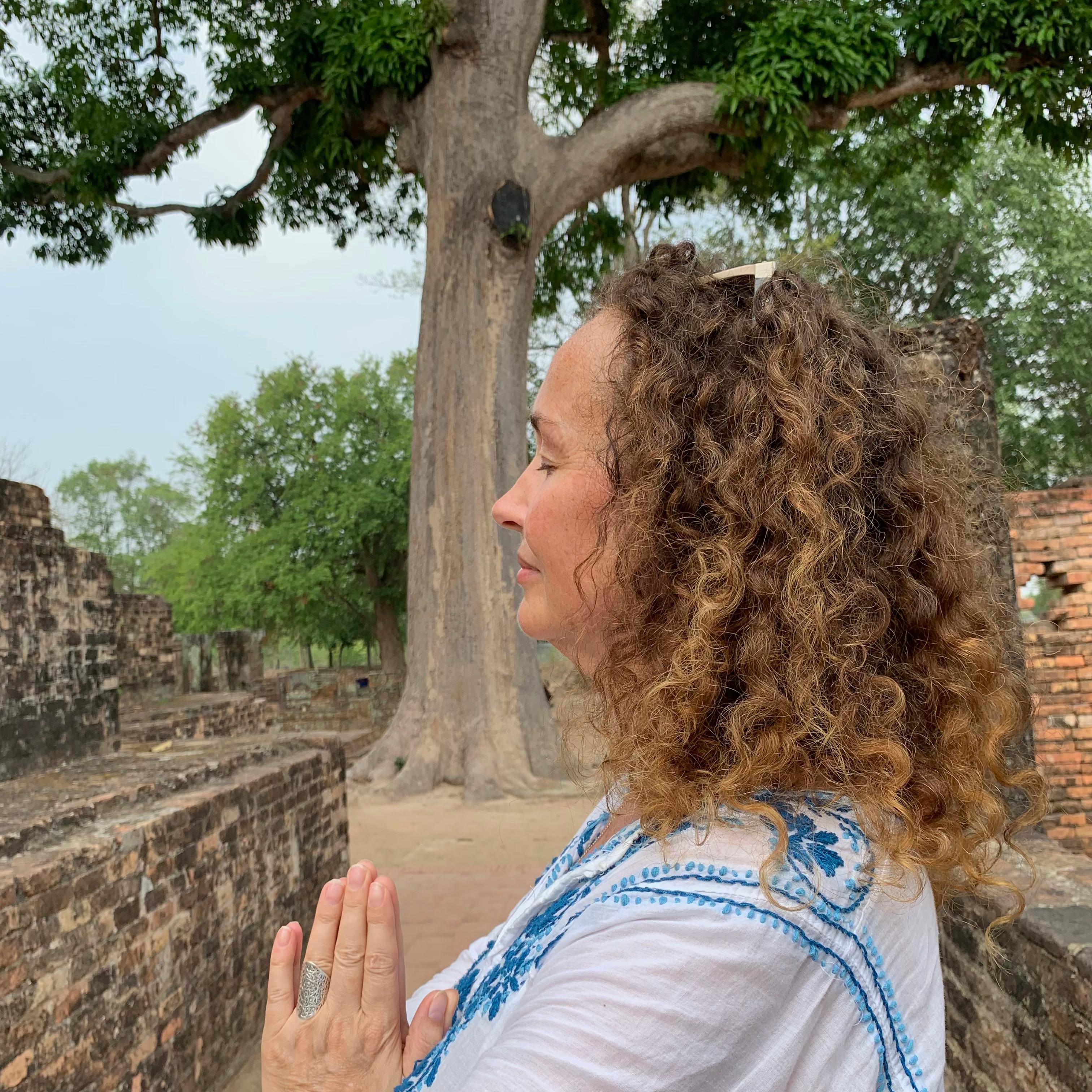 Joanna Sullivan in white shirt hands in prayer